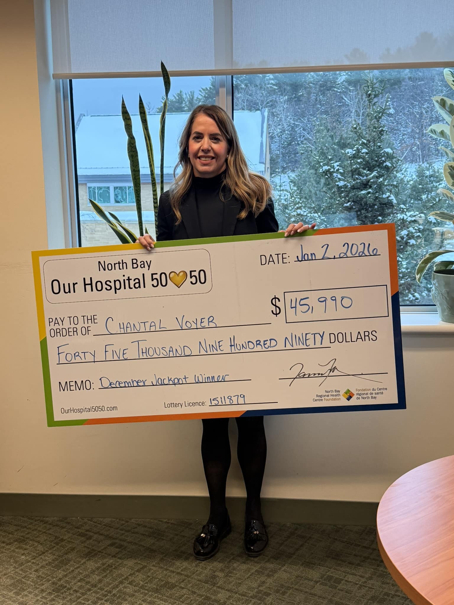 50/50 Winner Grant Matton standing with NBRHC Foundation Employee with oversized cheque. The cheque is for $66,242.